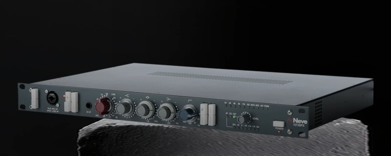 A rack-mount microphone preamplifier, lit hard on a concrete plinth.
